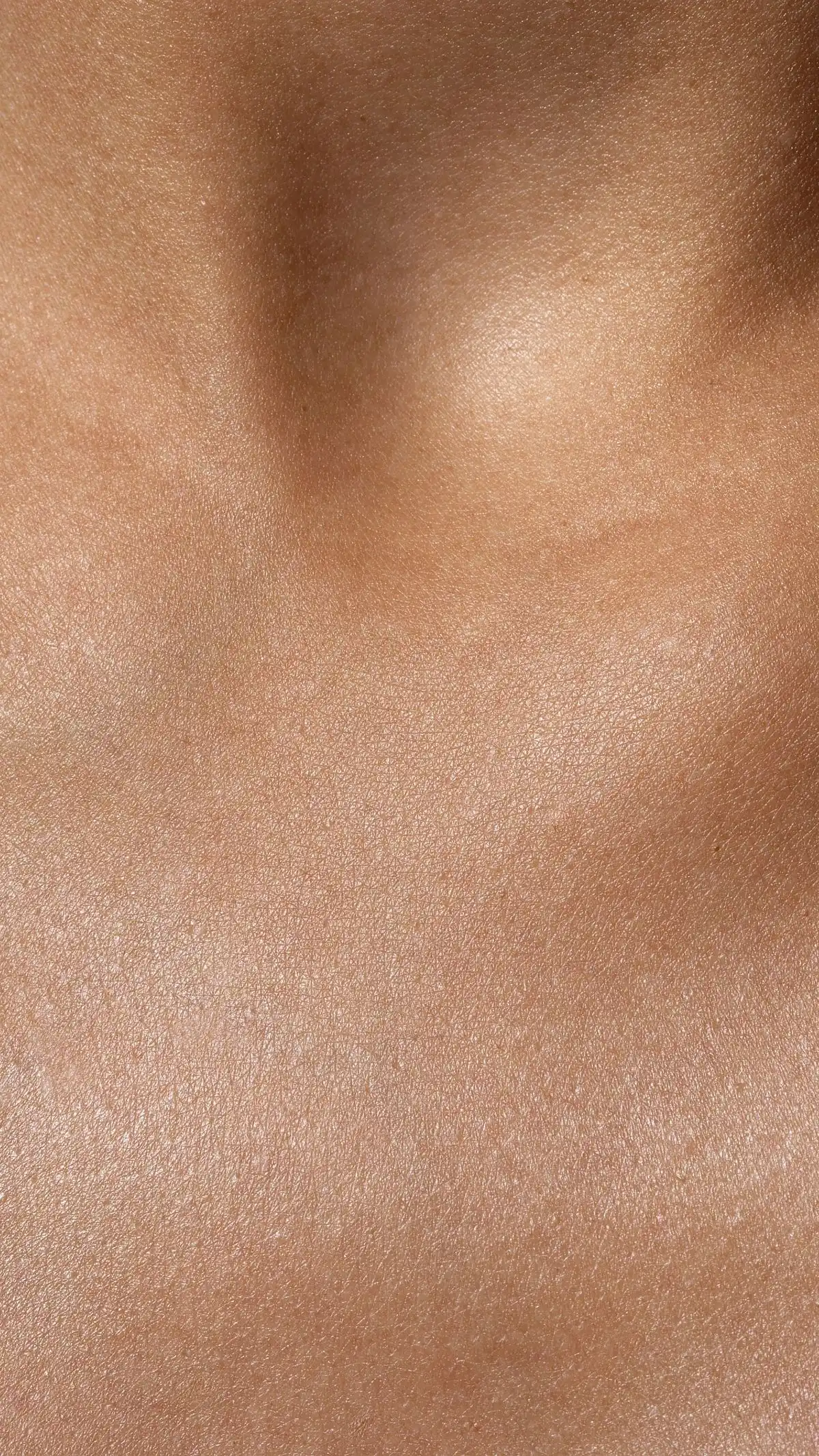 Extreme close-up of natural skin showing pores, fine lines and variations in surface texture
